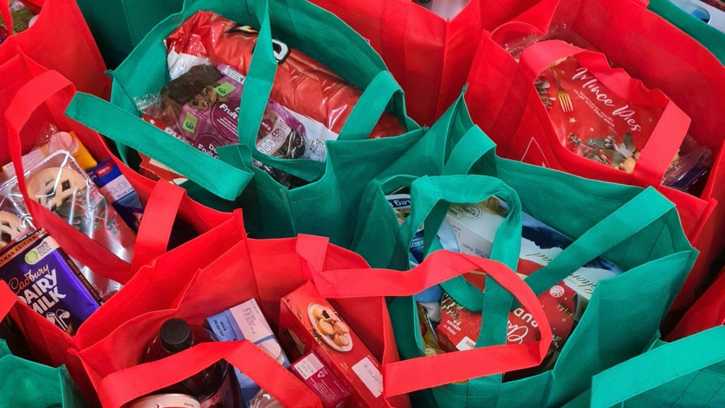 A row of grocery bags full of groceries