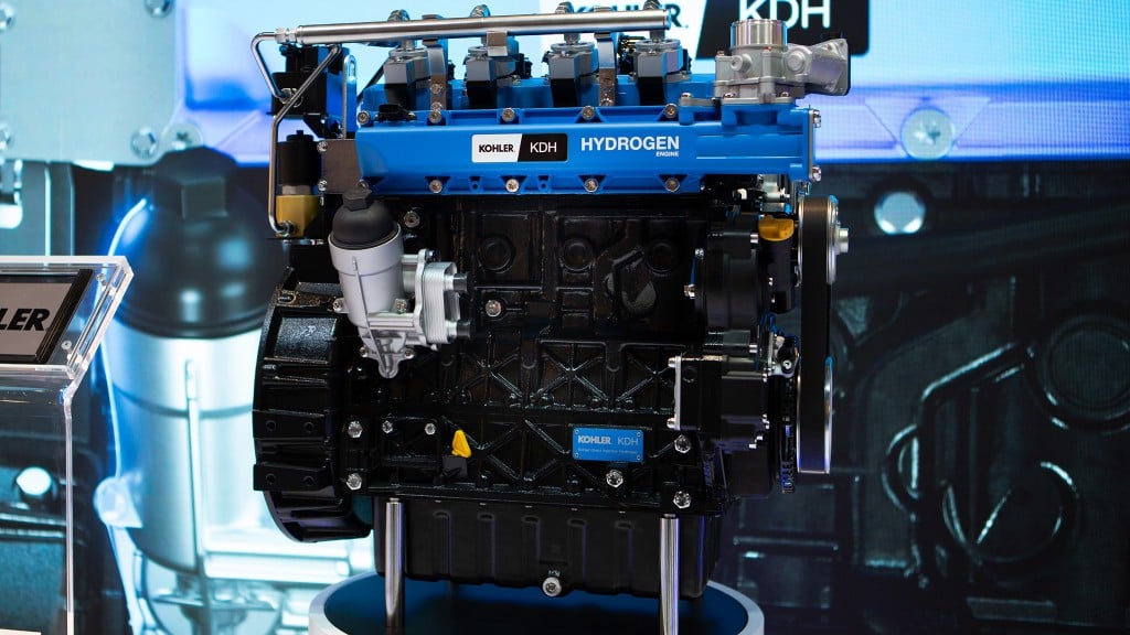 A blue and black industrial engine on a display stand.