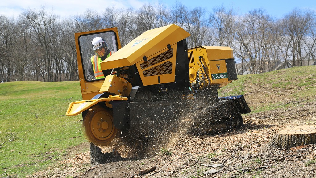 A stump cutter grinds down a stump