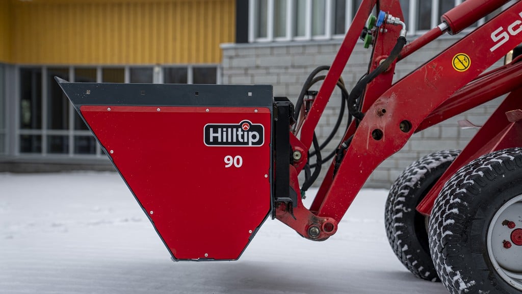 Hilltip drop spreader mounts on front or back of compact tractors and loaders
