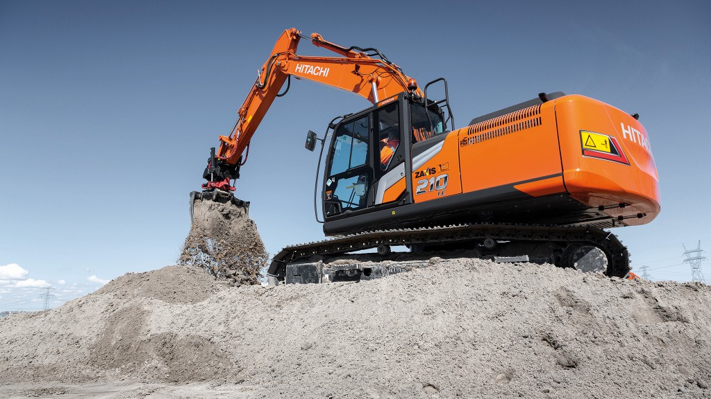 An excavator digging on a pile.