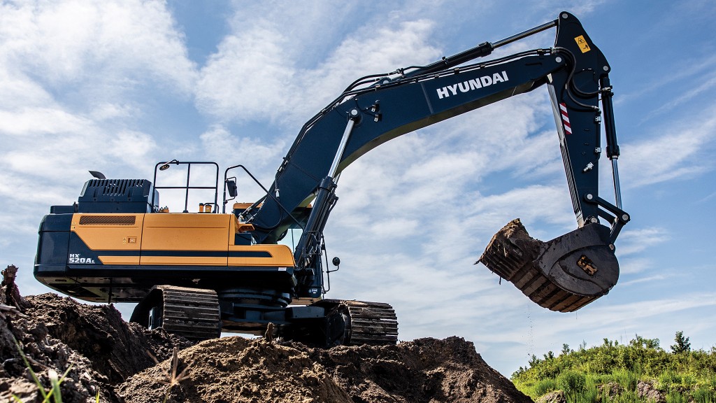 An excavator parked on top of a pile.