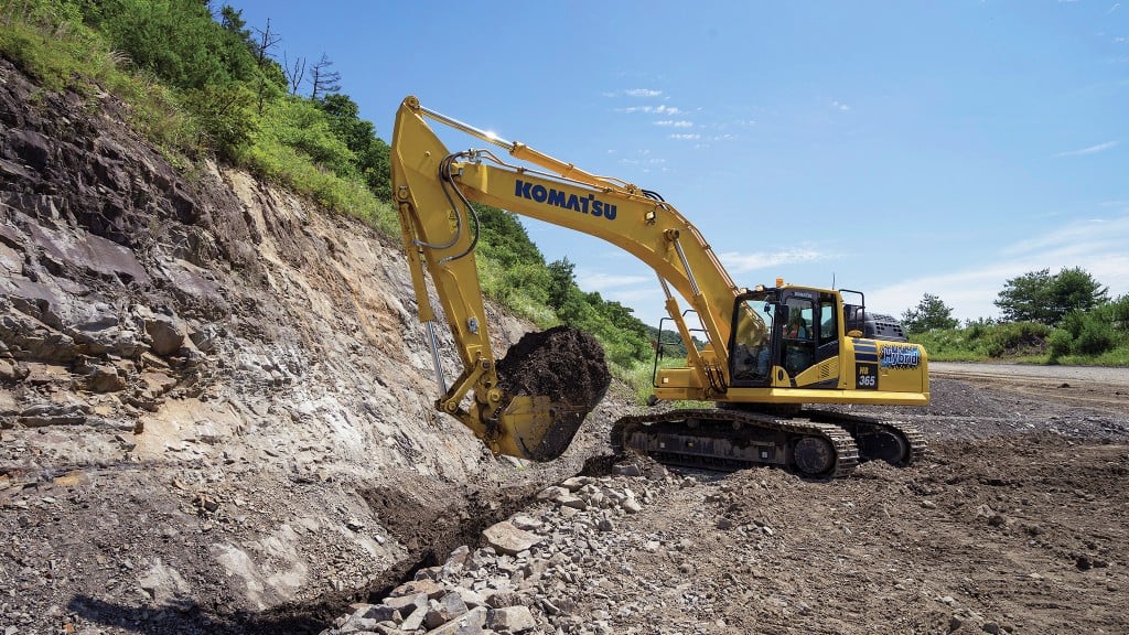 An excavator works next to a road.