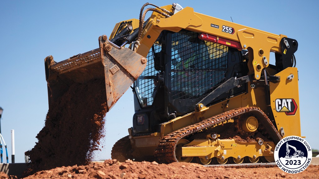 A compact track loader dumps dirt out of its bucket