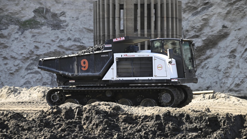 A crawler dumper moves earth on a construction site
