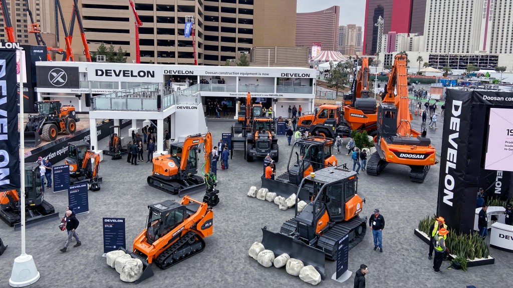 A busy trade show booth full of construction equipment