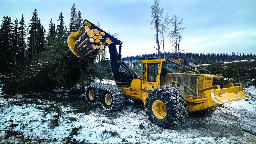 A skidder moves a bale of trees around