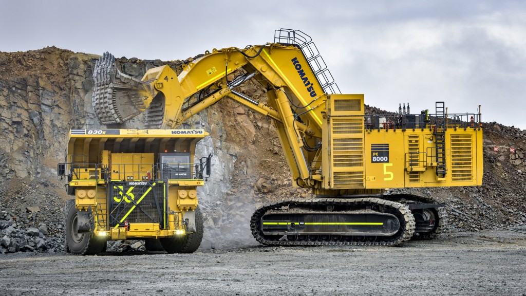 A large mining shovel loads a mining truck.