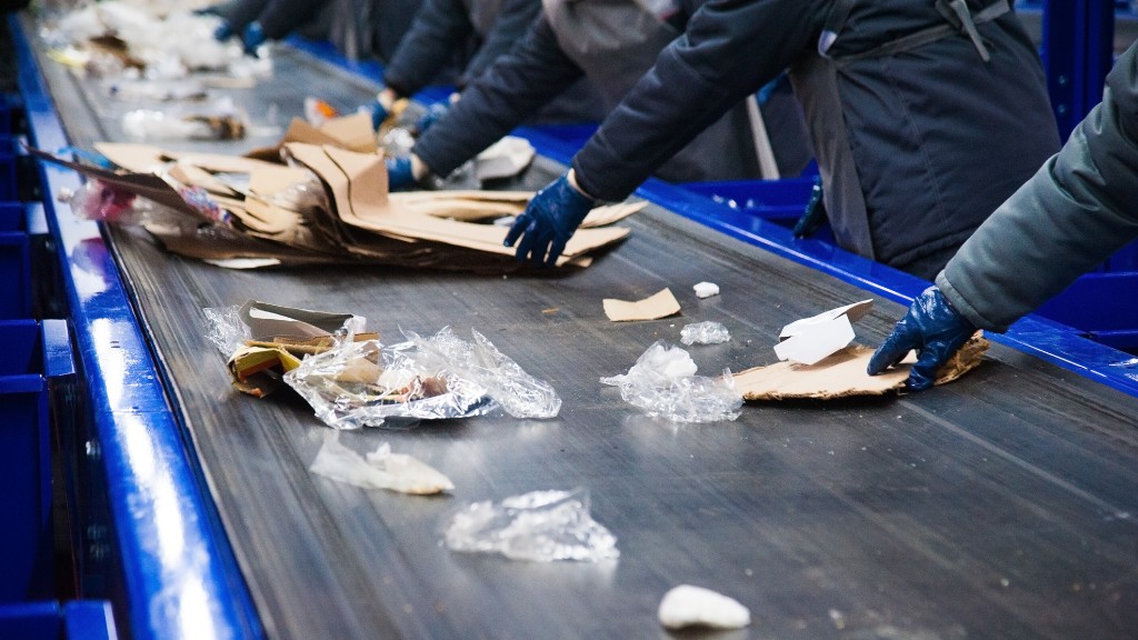 Workers sort recyclables on a line