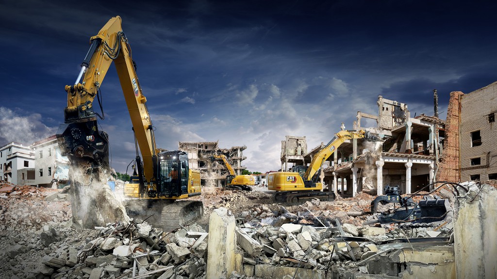 Two demolition excavators working amid a variety of construction debris