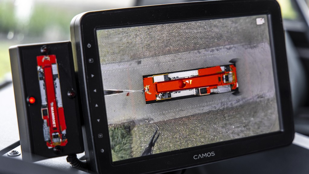 An in-cab monitor with an overhead image of a mobile crane.