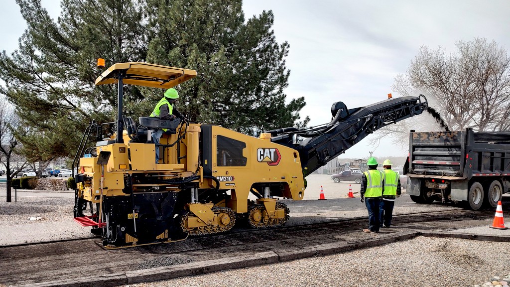 A cold planer working along a road.