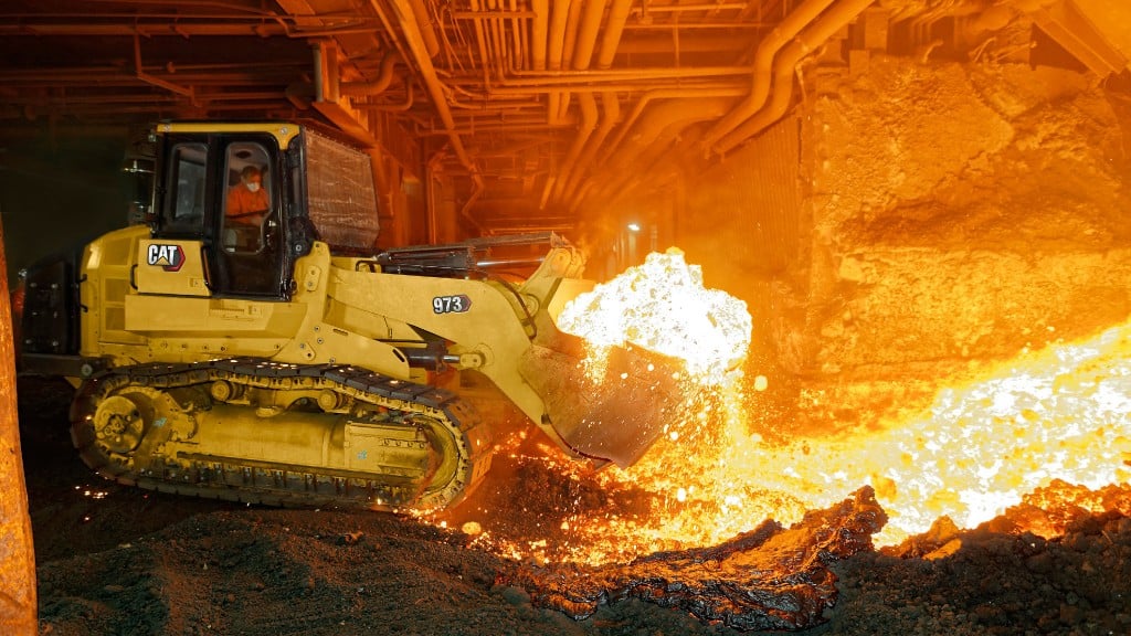 A track loader operates inside a steel mill
