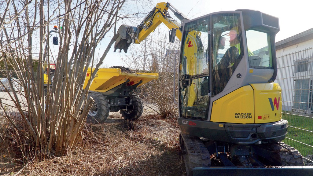 A mini excavator fills a site dumper with dirt