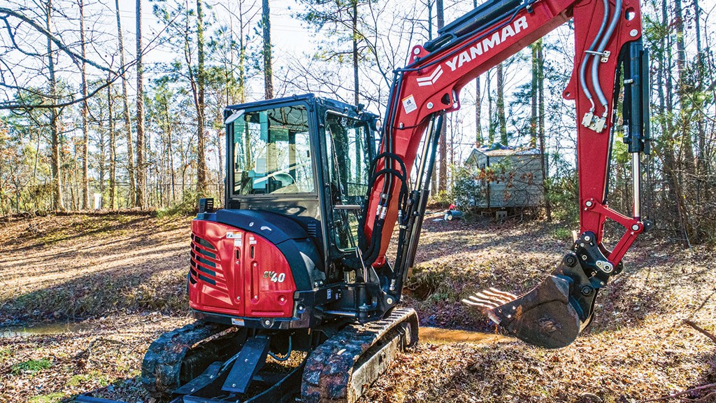 A compact excavator is parked at a job site