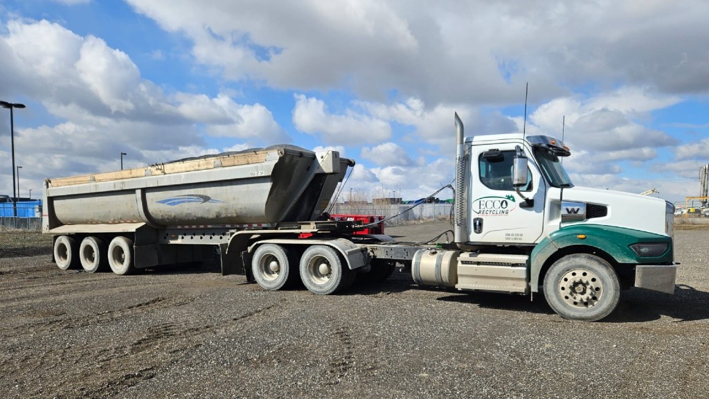 A truck delivers a load of asphalt shingles