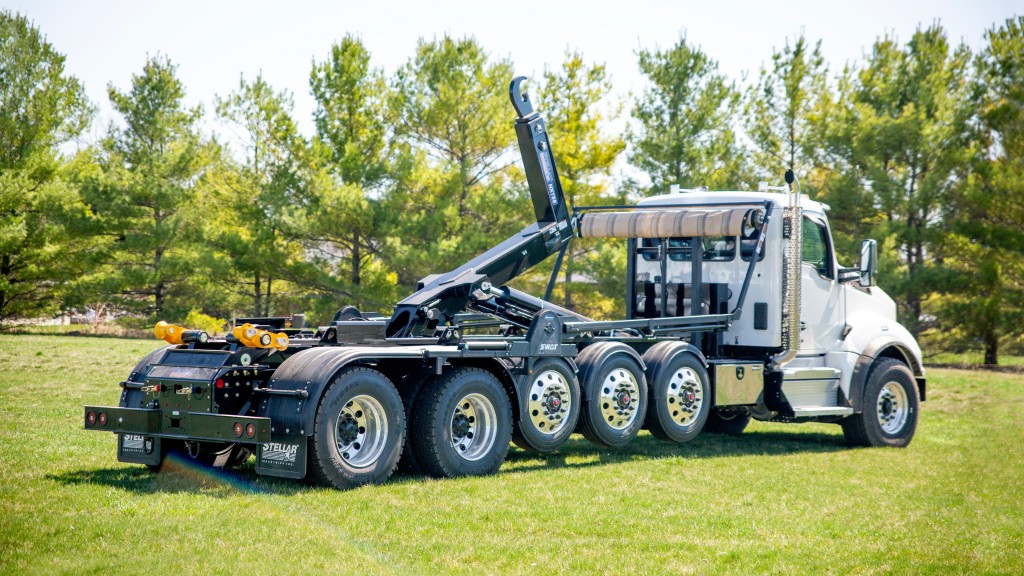 A hooklift parked on a field