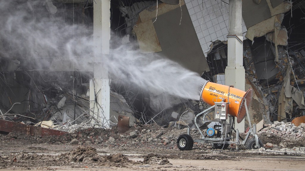 A misting cannon sprays water onto a job site