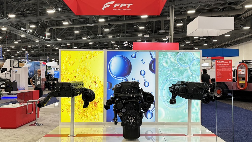 An engine and cylinder heads on a trade show display.