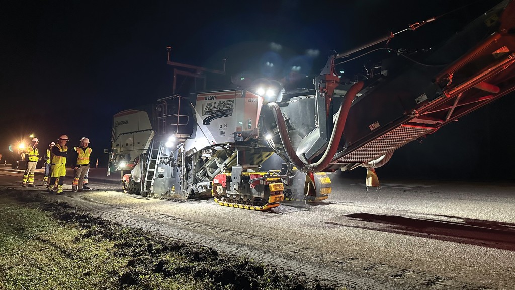 A cold milling machine operates on a highway paving job