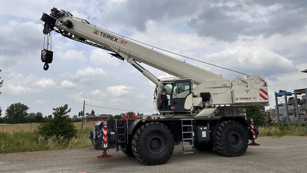 A rough terrain crane is parked on a job site