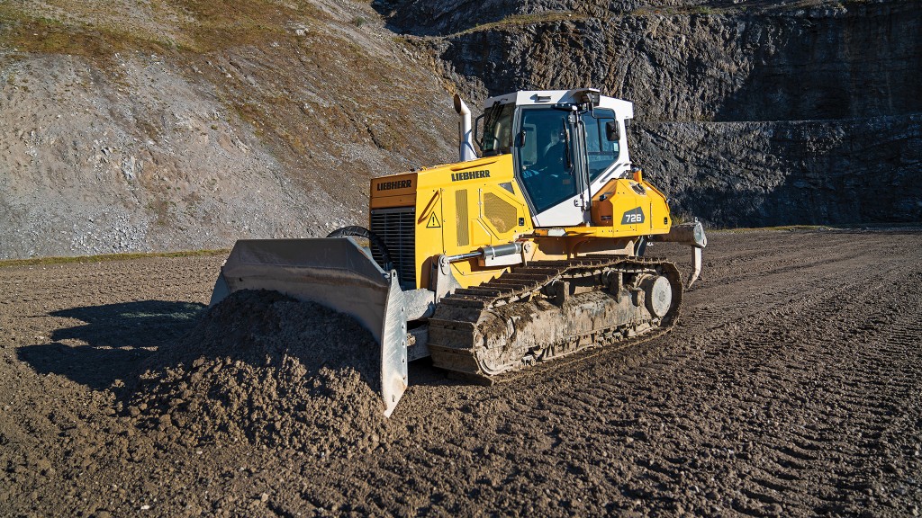 A Liebherr dozer pushes dirt on a job site