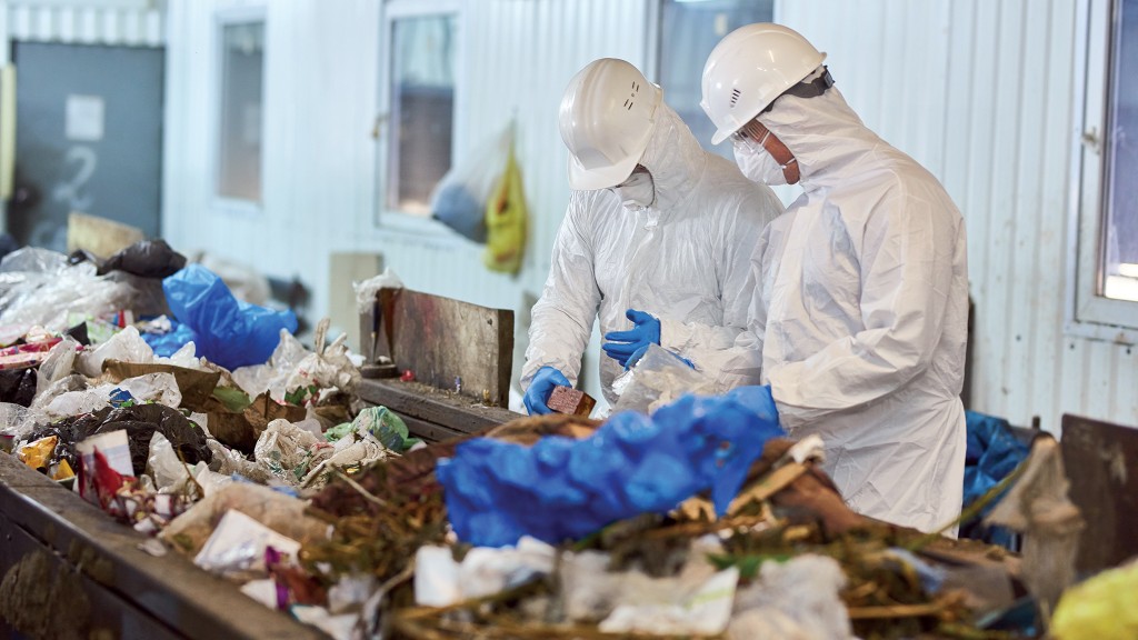 Workers sort through a large pile of materials