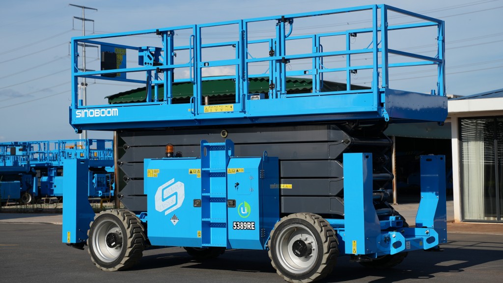 A scissor lift is folded up and parked