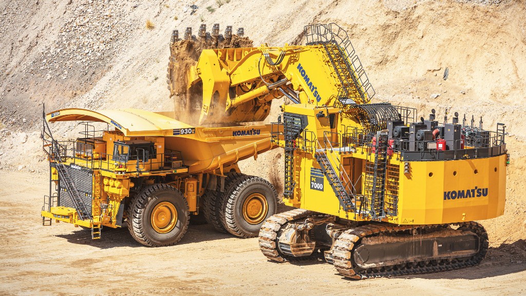 An excavator loads a haul truck