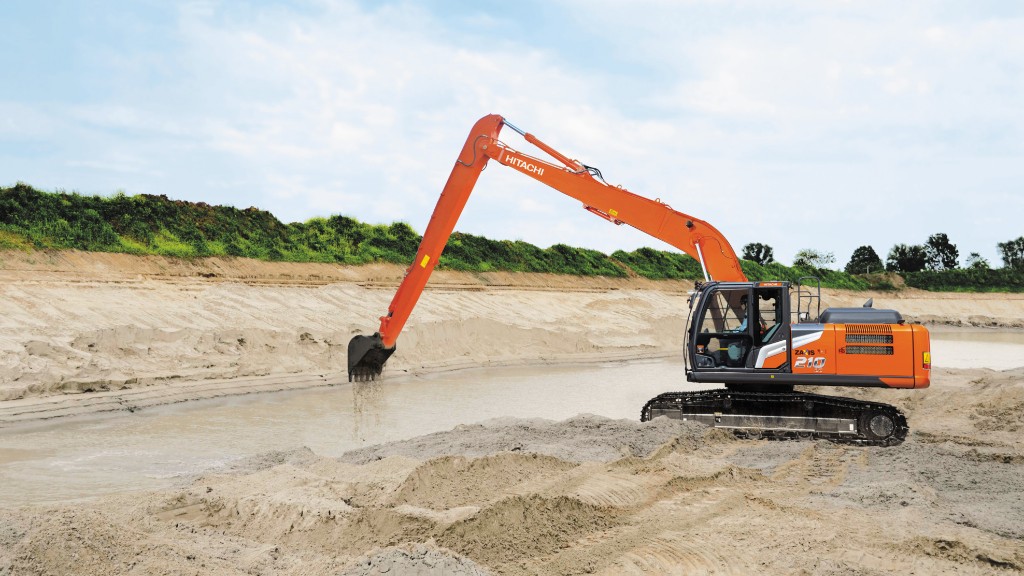 An excavator uses its long reach to complete work in a canal