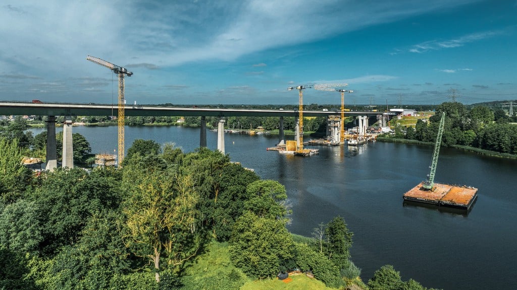 Cranes are set up and transported across a river