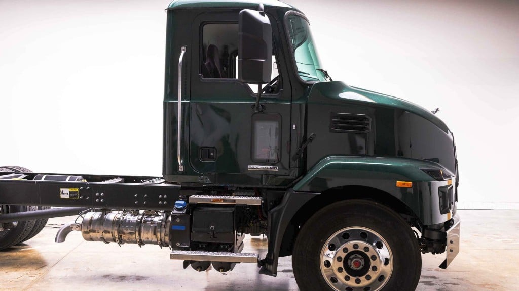 A Mack truck is parked inside a facility