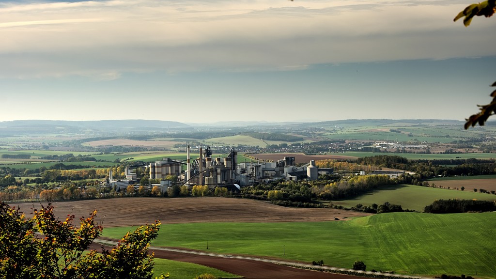 An industrial cement plant in the distance