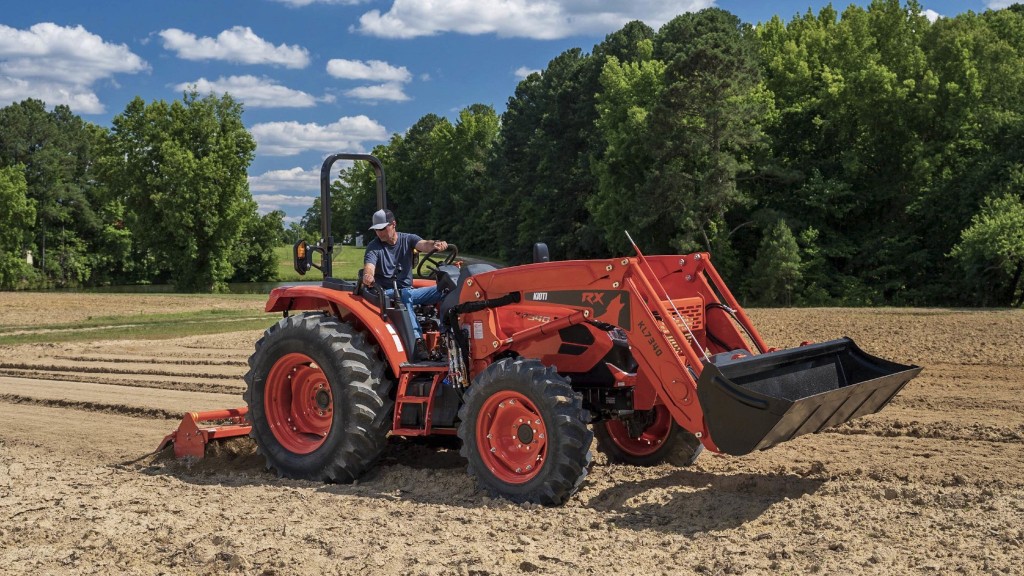 An operator uses a tractor to till a field