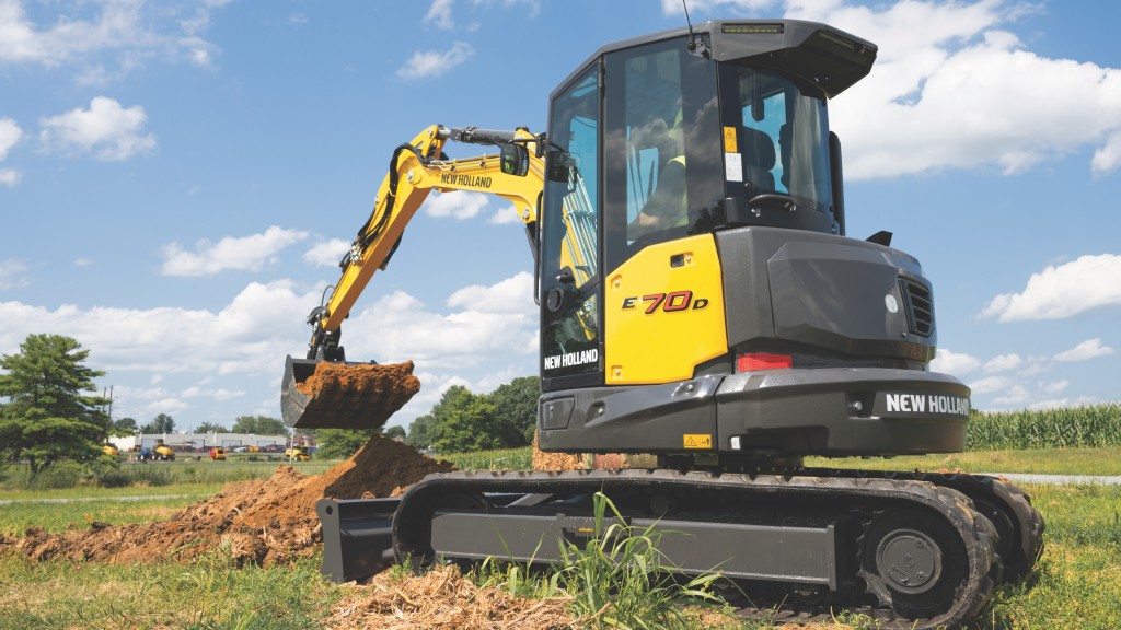 A compact excavator digs a hole on a job site