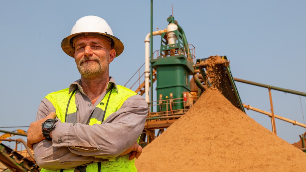 Keith Newell stands near an aggregates pile