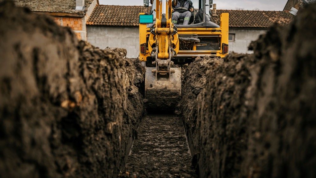 A backhoe digs a trench