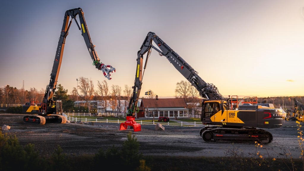 Two demolition excavators at sunset