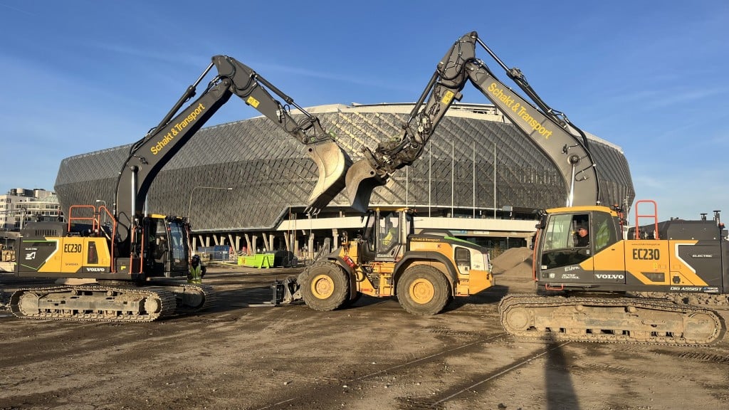 A view of the redevelopment of the ‘Slakthusområdet' neighbourhood in Stockholm, Swedeen with two Volvo electric excavators in the foreground and a large round building behind them