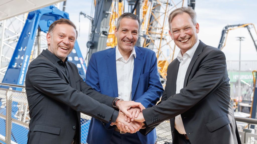 Three men standing together and shaking hands Three men standing together and shaking hands