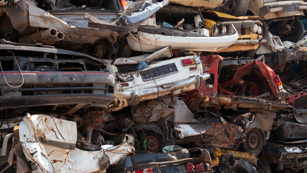 A junk yard filled with old scrapped cars A junk yard filled with old scrapped cars