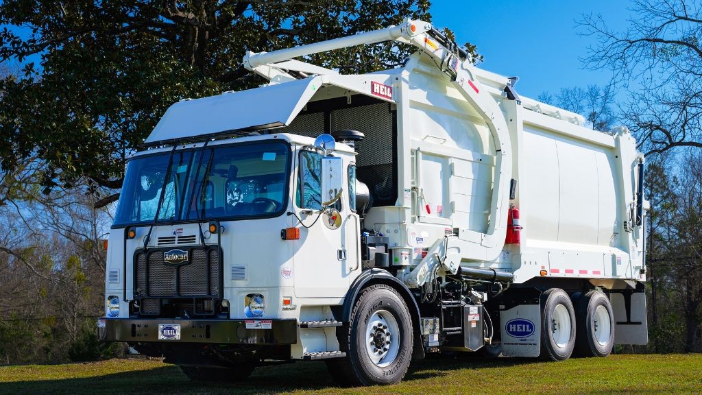A large white truck with front loading refuse capabilities A large white truck with front loading refuse capabilities