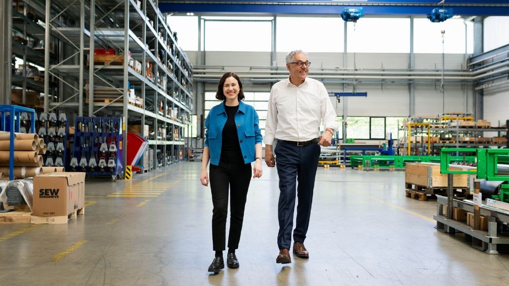 Julia Stadler and Willi Stadler walk through a warehouse together