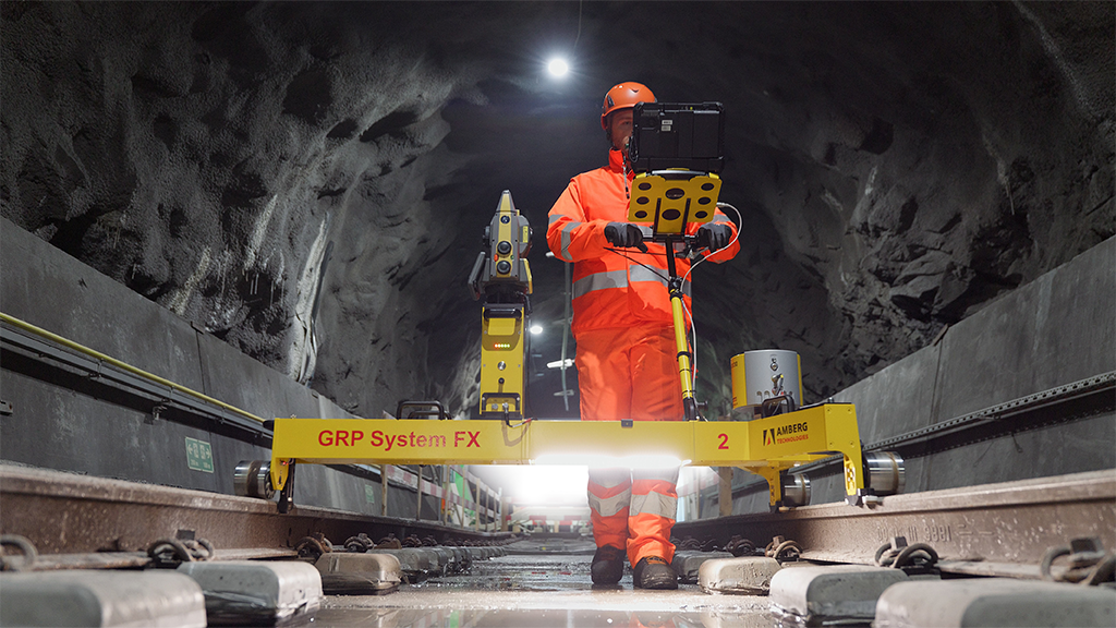 A man operating a tablet system in an underground railway