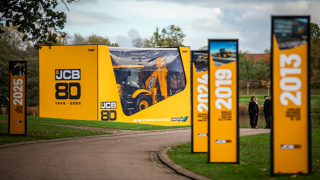 A replica of a JCB backhoe loader in a life-sized toy box A replica of a JCB backhoe loader in a life-sized toy box