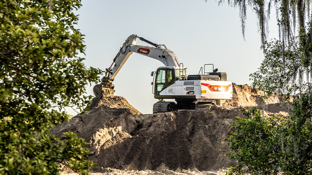 An excavator perched on a ridge An excavator perched on a ridge