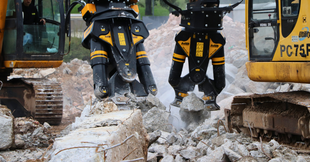 Two excavators use rock breaking attachments