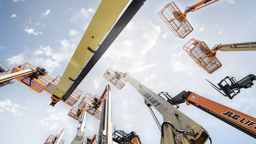 An upward view of several baskets on boom lifts