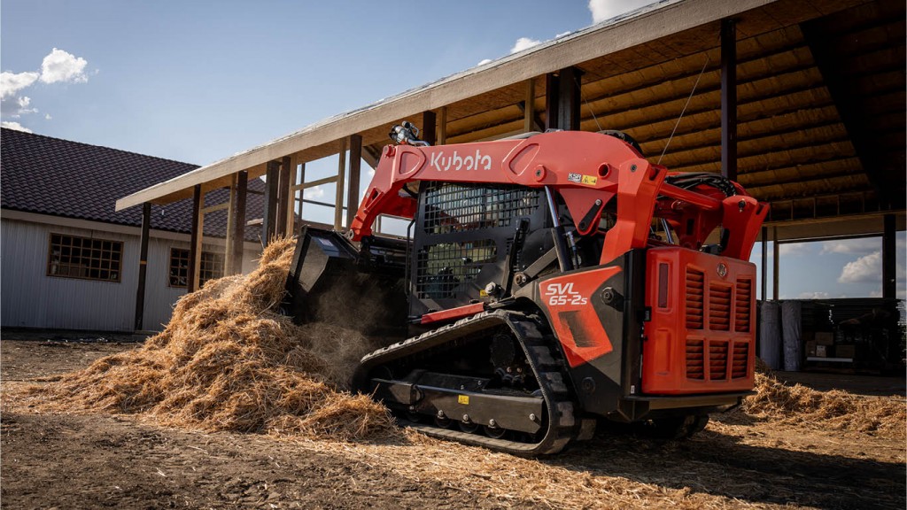 A compact track loader working on an outdoor site