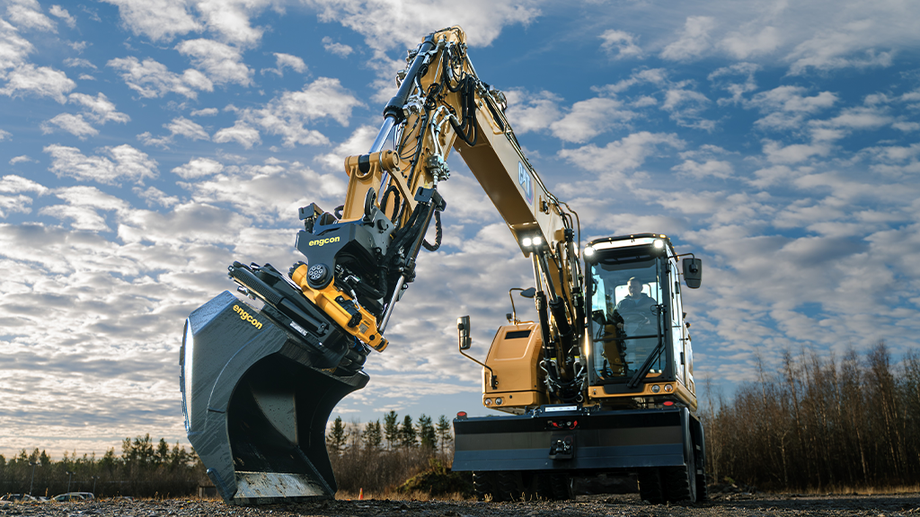 A wheeled excavator with a tiltrotator attachment
